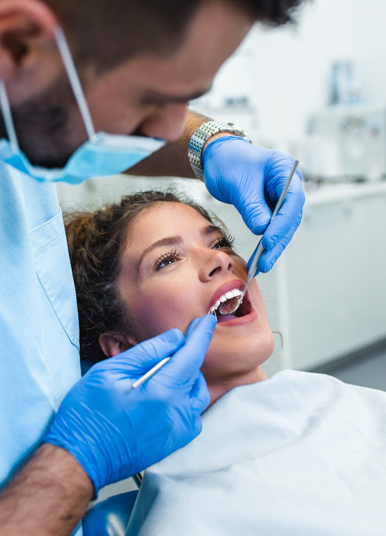 Beautiful young woman having dental treatment at dentist's office.