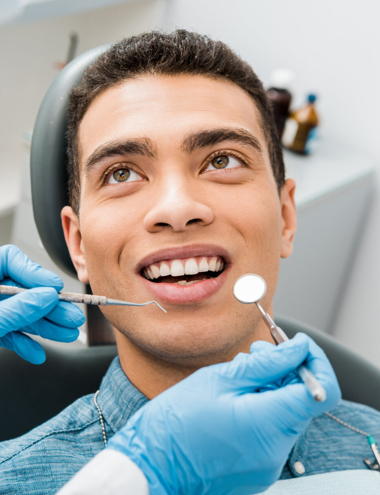 cheerful african american man with during examination in dental clinic