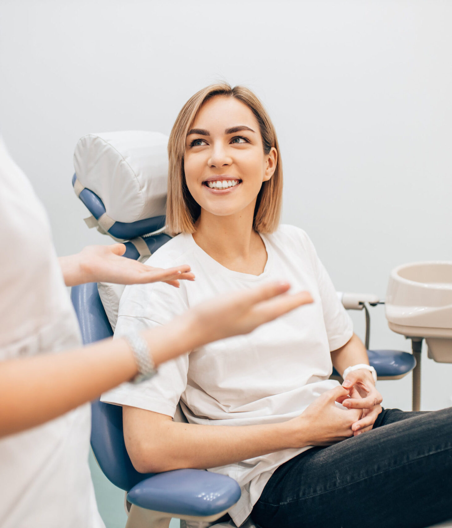 young beautiful lady with blond short hair sit in dentist office, waiting for a teeth treatment. Medicine, dentist concept