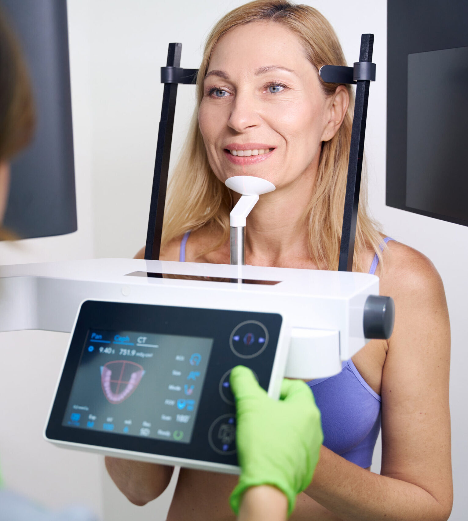 Patient undergoing dental cone-beam computed tomography carried out by experienced radiographic technologist