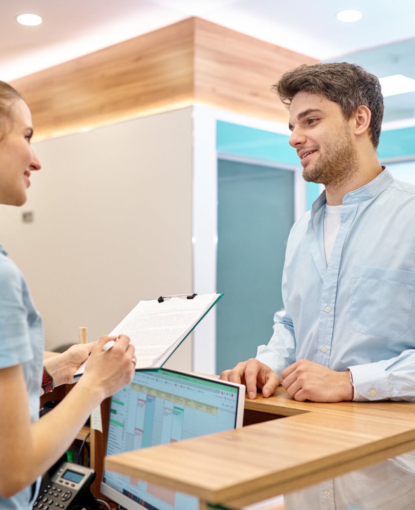 Receptionist greeting a patient at Revive Dentistry near Deltona, FL