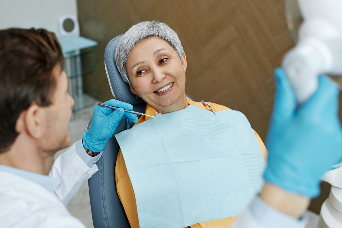 Dentist consulting with senior patient about dental implant candidacy