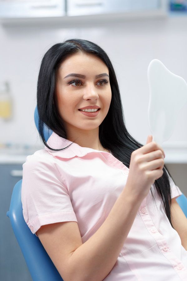Young woman smiling in dental chair