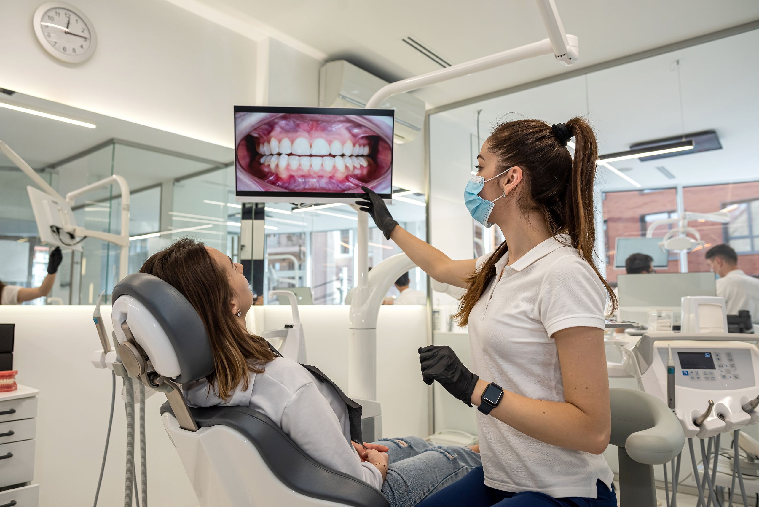 Dentist examining a young patient's teeth during a comprehensive dental exam