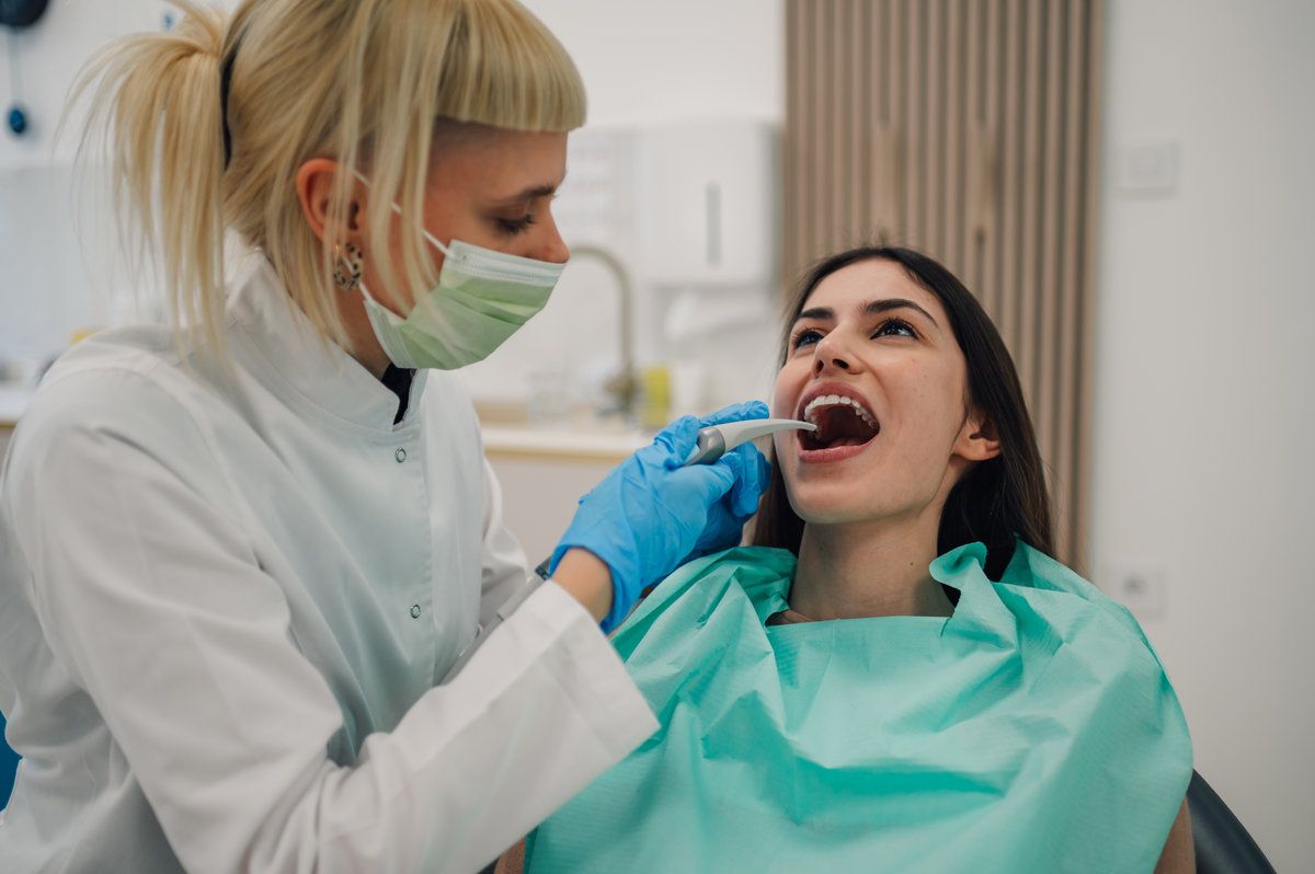 Dentist examining patient in clinic