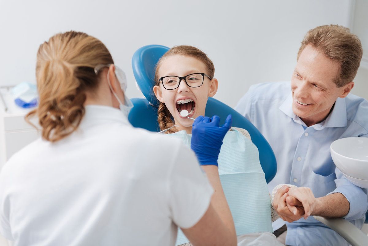 Family at a dental appointment, smiling.