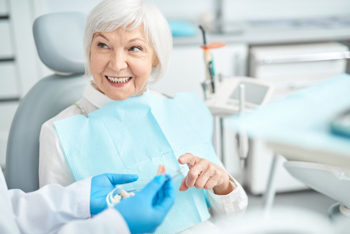 Smiling elderly woman at dentist