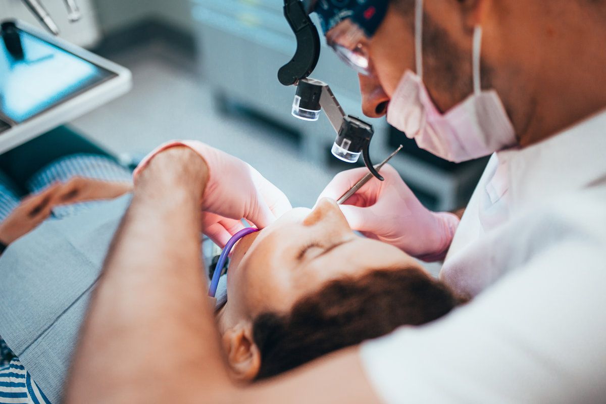 Dentist treating patient in clinic