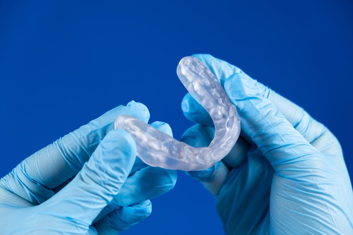 Hands holding a dental mouthguard