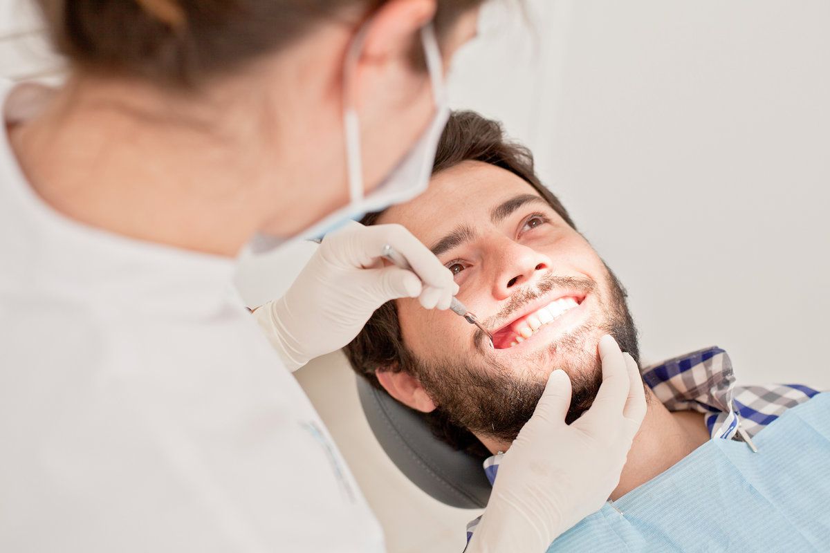Smiling man at dental clinic