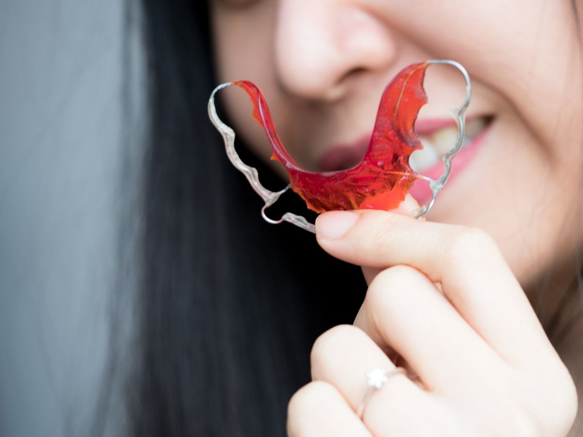 Closeup beautiful smiling woman with retainer for teeth. Concept Orthodontics Dental,